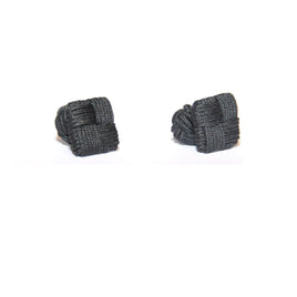 A pair of sleek black square cufflinks displayed against a crisp white background.