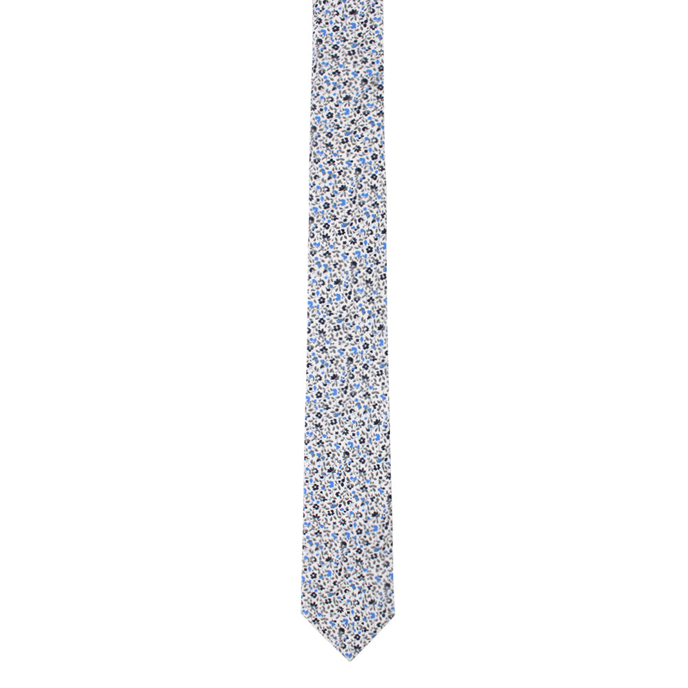 A Black Light Blue Floral Skinny Cotton Tie with bold contrasts of blue and white flowers on it.
