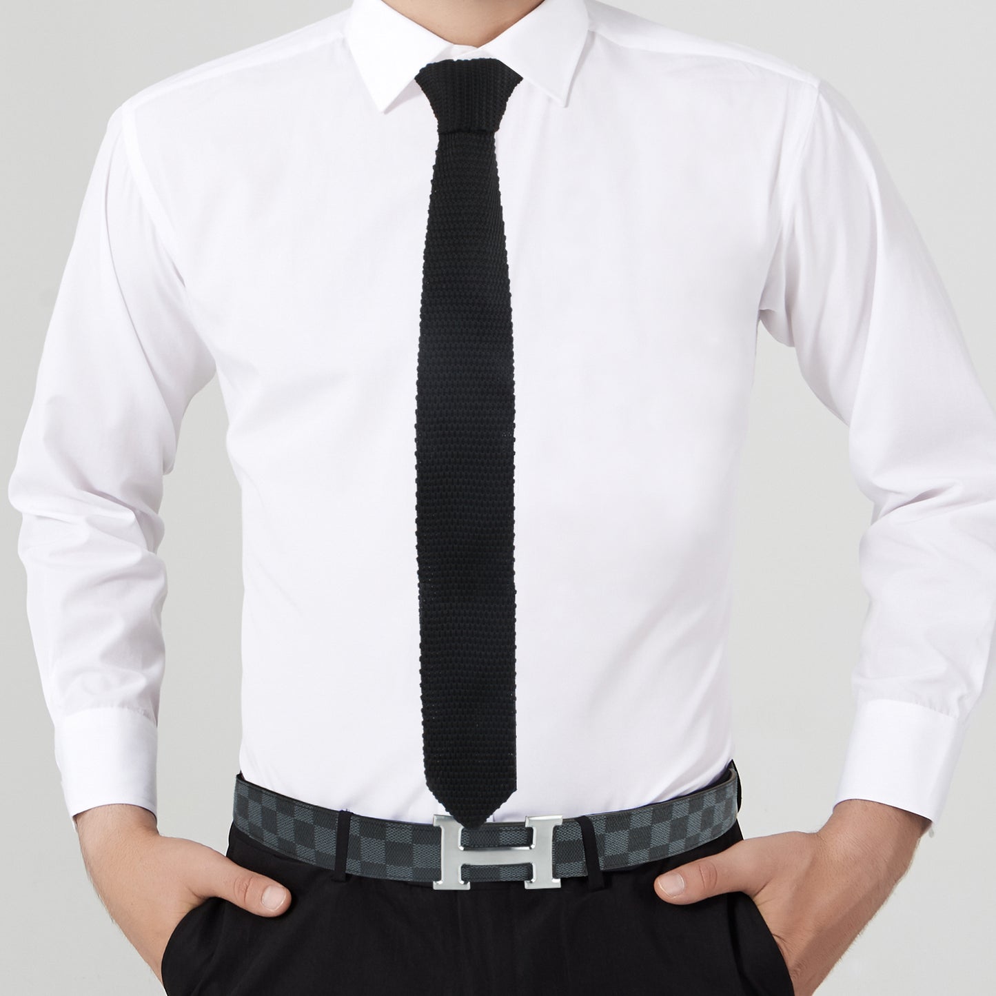 A man exuding elegance in a white shirt and Black Skinny Necktie.