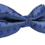 Introducing the Blue Flower Grey Bow Tie, showcasing a sophisticated design of light blue flowers on a dark blue background.