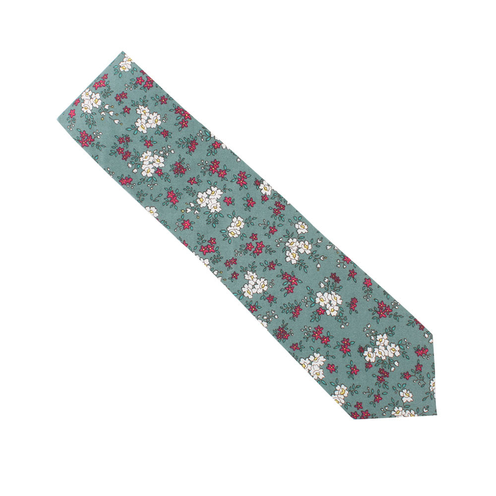 The Teal Floral Skinny Cotton Tie exudes sophistication with its teal color, featuring a floral pattern of small white and red flowers, enhanced by subtle herringbone accents.