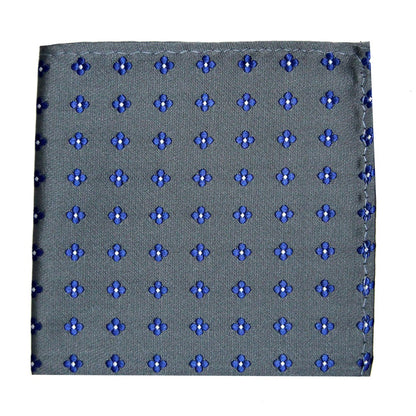 A folded, square-shaped, gray pocket square with a blue and black floral dot pattern exudes a subdued charm and tasteful appeal. The Blue Flower Grey Business Tie & Pocket Square Set offers a sophisticated finishing touch to any formal attire.