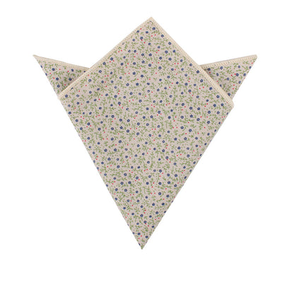A folded pocket square featuring an elegant floral design with hints of blue on a white background from the Blue Forget-Me-Nots Cotton Floral Skinny Tie & Pocket Square Set.