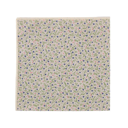 A square piece of fabric adorned with an elegant pattern showcasing delicate pink, blue, and green florals comes as part of the Blue Forget-Me-Nots Cotton Floral Skinny Tie & Pocket Square Set.