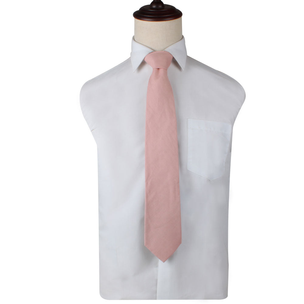 A mannequin showcasing soft elegance in a Blush Pink Skinny Necktie and Pocket Square Set.