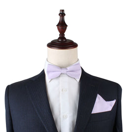 A mannequin with a blush purple bow tie and pocket square set.