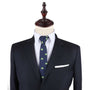 A black suit with a Brazillian Flag Necktie and pocket square.