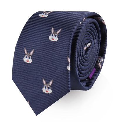 The Bunny Skinny Tie is a rolled-up accessory in navy blue, featuring a pattern of smiling bunny faces that exudes charming sophistication.