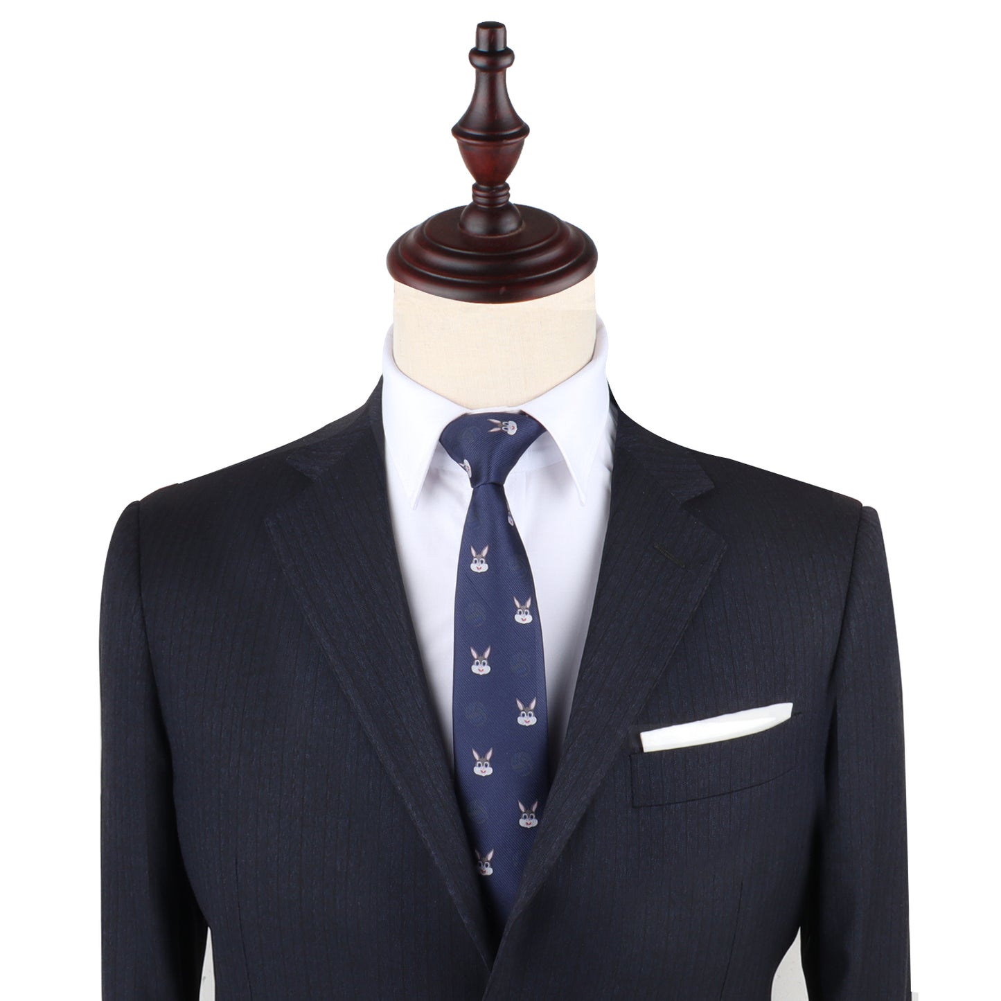 A mannequin exudes charming sophistication in a dark suit paired with a white shirt and the Bunny Slim Tie. The ensemble is accented by a white pocket square, showcasing elegant clothing that speaks to sophisticated fashion.