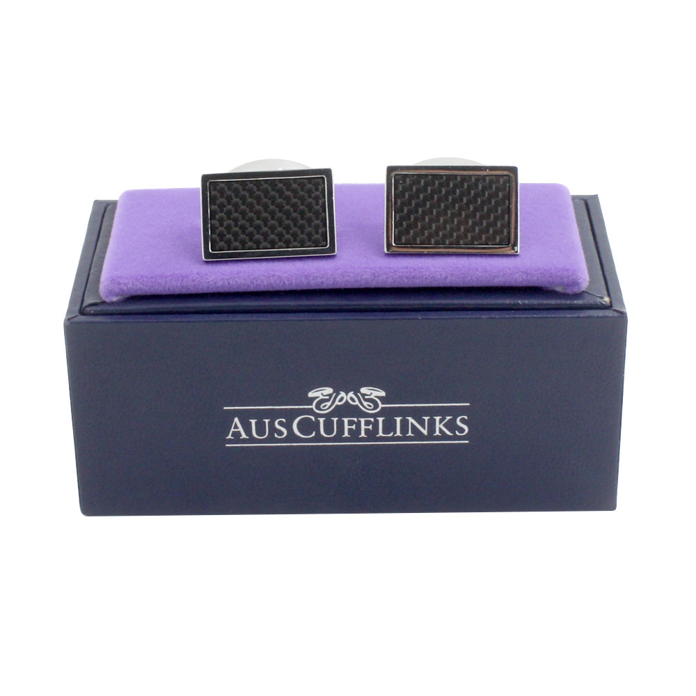 A pair of Carbon Fibre Cufflinks in a purple box with modern charm.