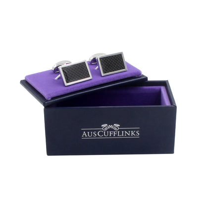A pair of Carbon Fibre cufflinks in a purple box with a modern charm.