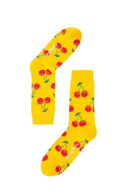 A pair of yellow Cherry Socks with cherries on them.