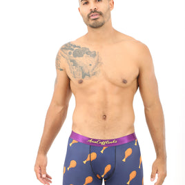 Clad in Chicken Boxers, a person stands in cozy comfort, sporting a quirky chicken drumstick pattern on their boxer briefs and revealing a tattoo on their shoulder.