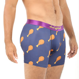 A person sporting Chicken Underwear features a fun chicken drumstick pattern on navy blue boxer briefs with a purple waistband, providing cuddly comfort.
