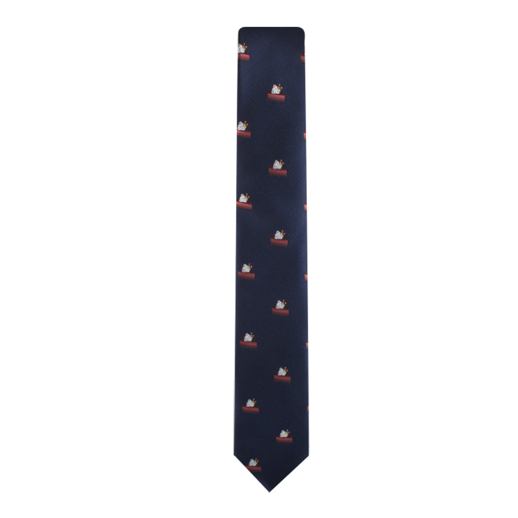 The Cake Skinny Tie, in a sophisticated navy blue, features an enchanting pattern of small white dog illustrations sitting in a boat, adding a touch of elegance to any attire.