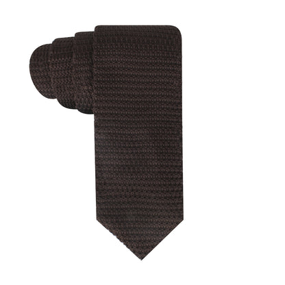 Introducing the Chocolate Knitted Tie, a dark brown knitted necktie featuring a textured pattern that exudes earthy vibes. Skillfully rolled up, it showcases its knitted finesse against a pristine white background.