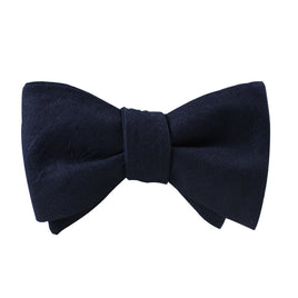 A versatile Classic Navy Self Tie Bow Tie on a white background.