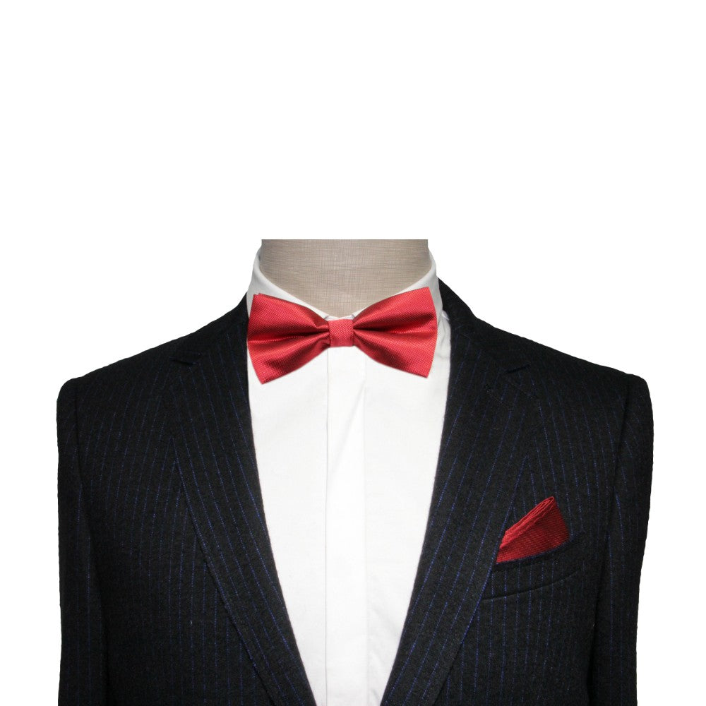 A man in a suit with a Classic Red Bow Tie.