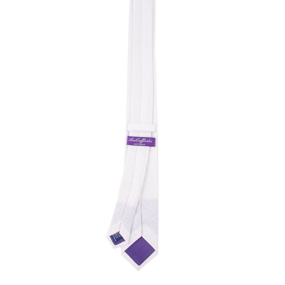 The Classic White Cotton Skinny Tie with a purple label and purple tipping exudes sartorial elegance, reminiscent of a garden in full bloom.