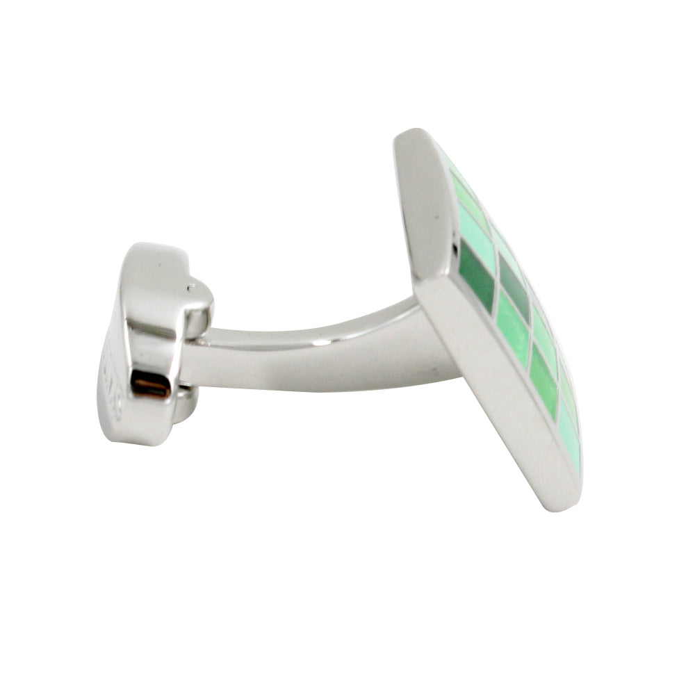 A polished coral green cufflink with green and white tiles, exuding tropical elegance.