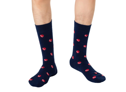 A man wearing a pair of Cricket Socks with red hearts on them is sporting stylish socks.