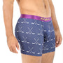 A man wearing the Crossed Ice Hockey Underwear, which features a stylish navy dual stick hockey pattern and a purple waistband, stands in a side pose to highlight both comfort and fashion.