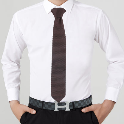 A man wearing a Dark Brown Skinny Tie and black belt.