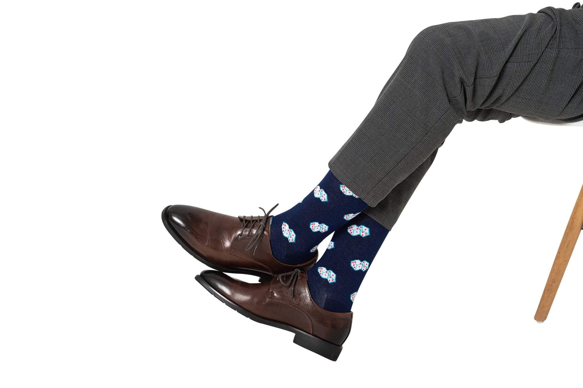 A pair of legs with brown shoes and Dice Socks.