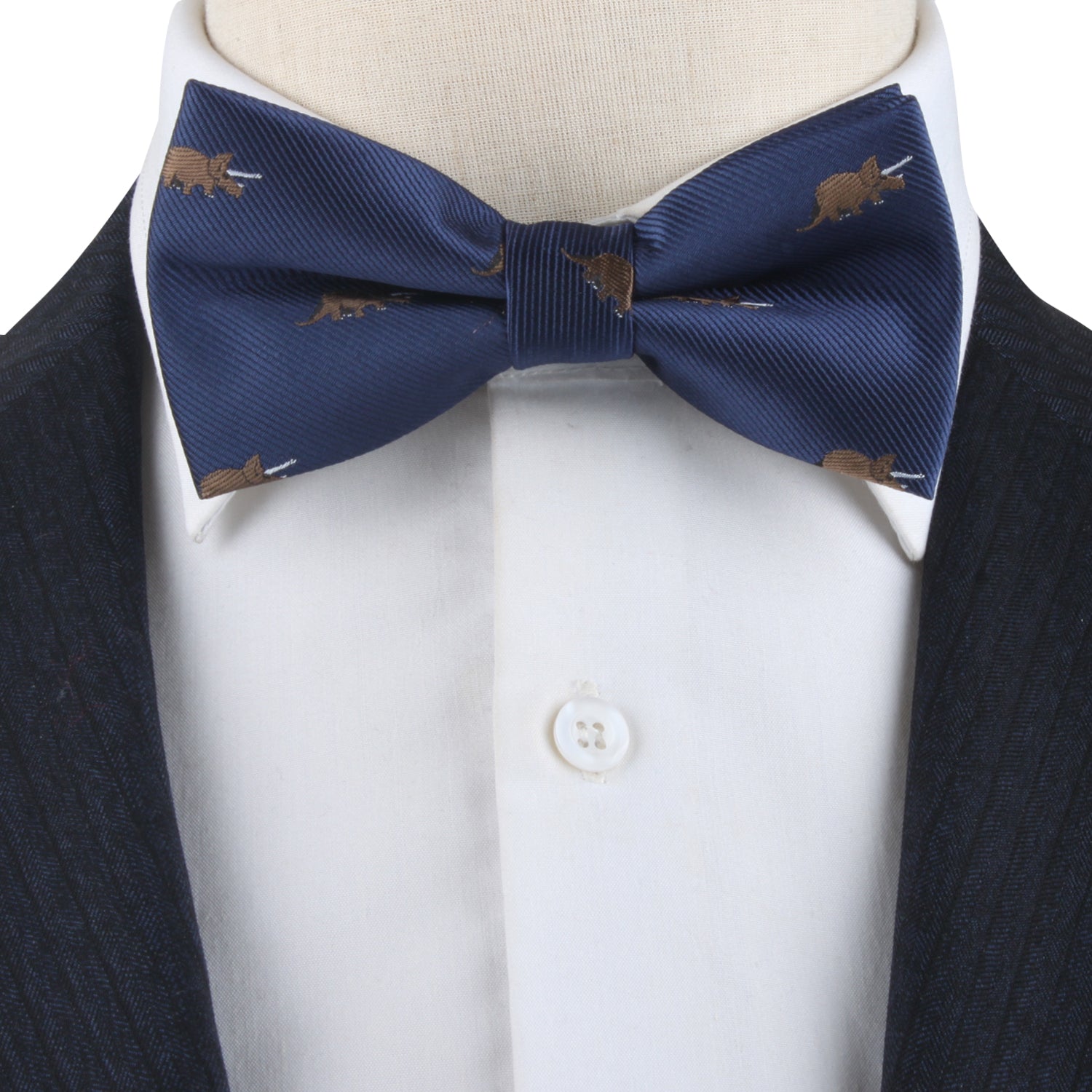A Triceratops Bow Tie, exuding Jurassic charm, elegantly complements a crisp white shirt and a dark pinstripe suit.