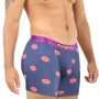 A man wears the Donuts Underwear, featuring navy boxer briefs with a fun pink donut pattern and a purple waistband, offering both comfort and a sweet touch.