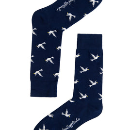 A pair of navy Dove socks with white birds on them.