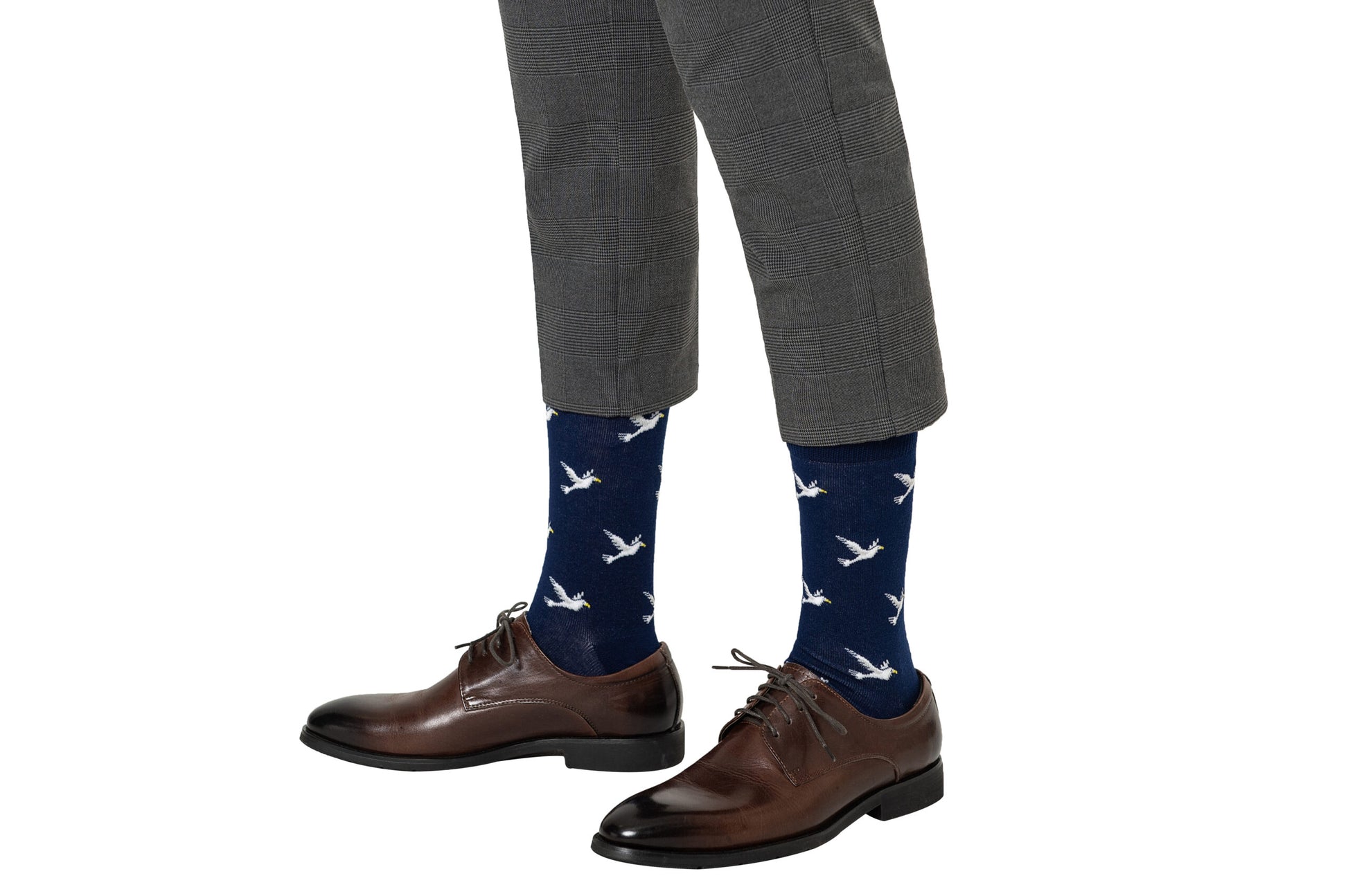 A man wearing a pair of Dove Socks with birds on them.