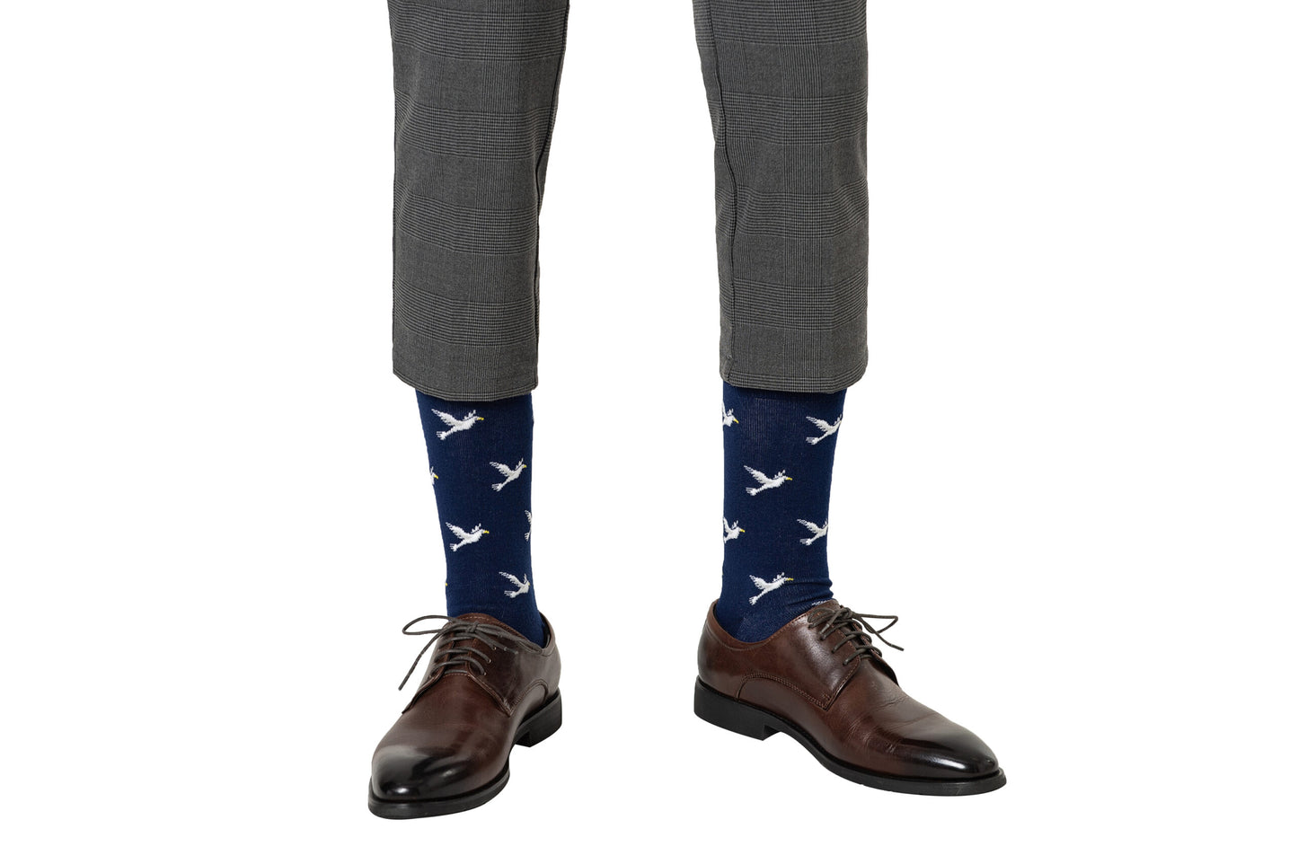 A man wearing a pair of blue Dove socks with white birds on them.