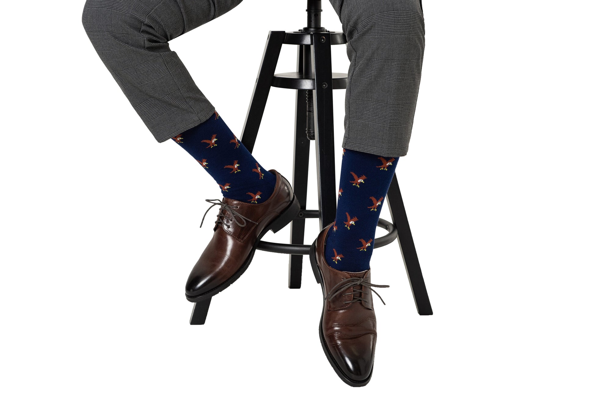 A man sitting on a stool wearing Eagle Socks.