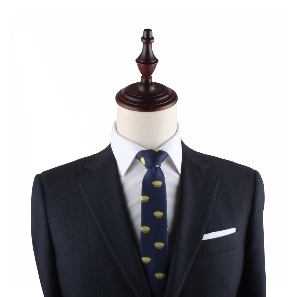 A mannequin dressed in a dark suit, white shirt, and the Egg Tart Slim Tie with yellow patterns stands as a delightful testament to sophisticated fashion.