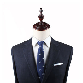 A mannequin dressed in a dark navy pinstripe suit, a white dress shirt, and an Elephant Slim Tie exudes grace and charm.