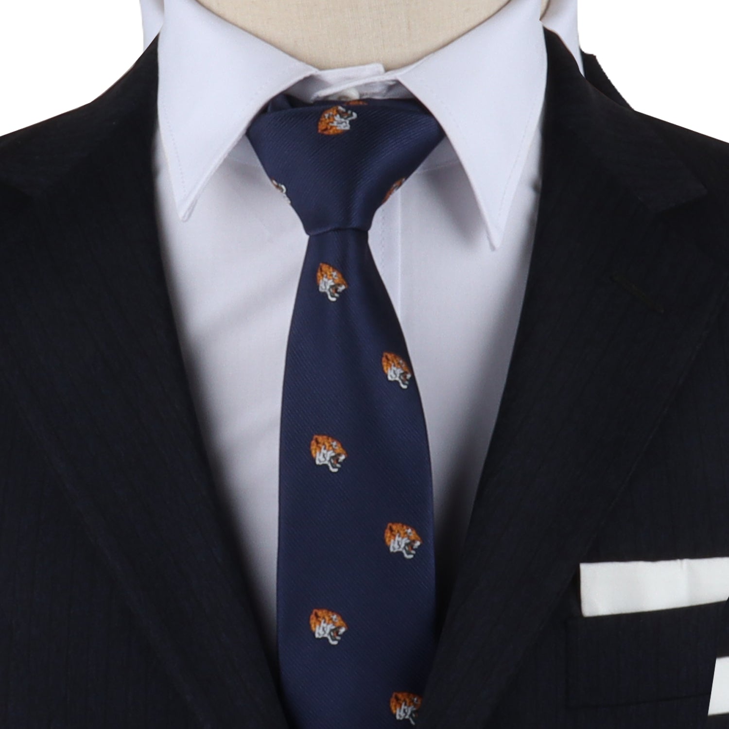 A person in a dark suit and white shirt makes a fierce fashion statement with the Tiger Skinny Tie, featuring a striking tiger emblem pattern.