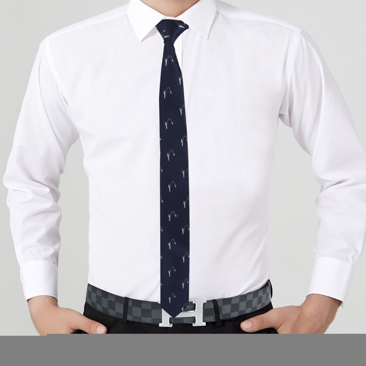 A person wearing a white dress shirt, Fishing Print Tie, and a checkered belt with a metallic buckle stands with hands on hips, effortlessly commanding attention and earning compliments.