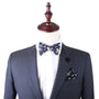 Mannequin dressed in a dark gray suit with a Floral Navy Yellow Self Bow Tie, white dress shirt, and matching floral pocket square, exuding unique elegance and floral charm.