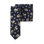 A tie featuring a deep navy blue reminiscent of the sea, embellished with delicate golden floral patterns and complemented by orange, yellow, white, and green accents.