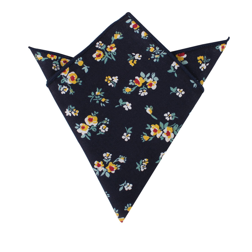 A pocket square in deep navy blue featuring a floral design with golden blossoms, white flowers, and orange accents.