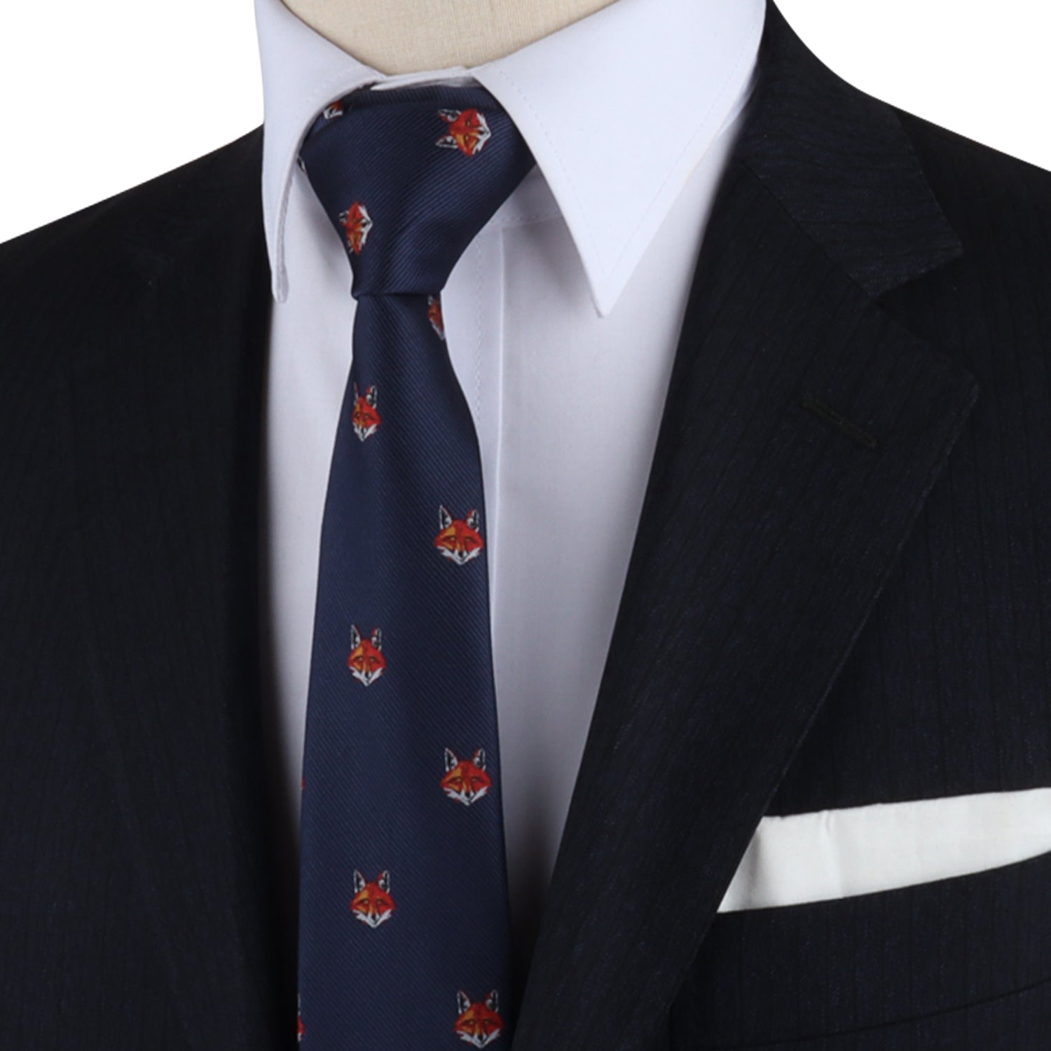 A mannequin showcasing a sleek design with a suit, Forest Theme Tie, and pocket square, exuding a hint of cunning charm.