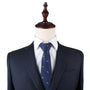 A mannequin dressed in a dark suit, white shirt, and an Fox Print Tie stands against a plain white background, subtly hinting at the wild allure of style.