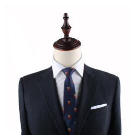 A mannequin dressed in a dark suit with a white dress shirt, the Fries Slim Tie featuring red and yellow accents, and a white pocket square exudes modern sophistication.