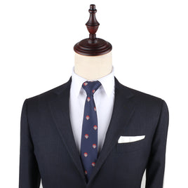Displayed on a mannequin, the Gamer Face Thin Tie complements a dark suit jacket and white shirt, offering an effortless way to elevate your fashion game.