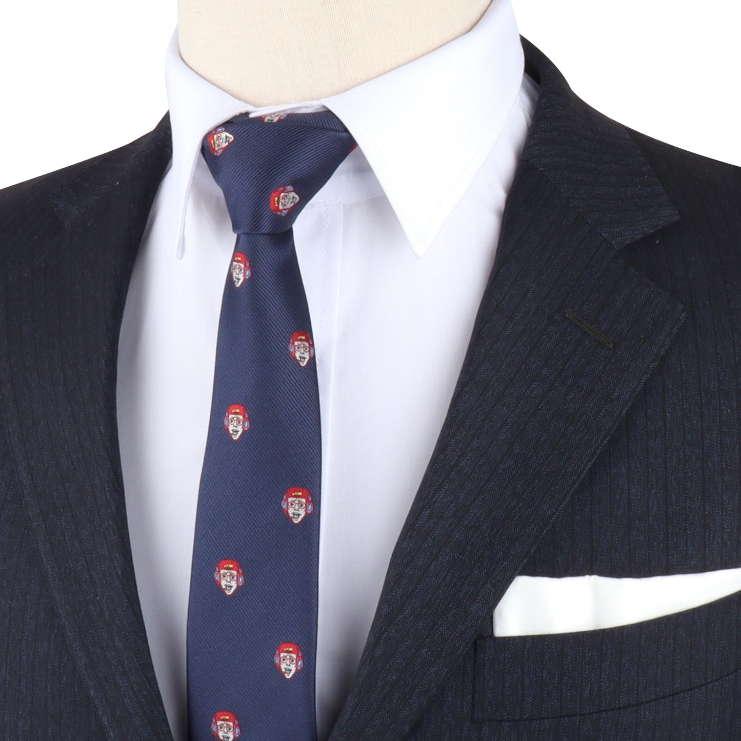 A mannequin dressed effortlessly in a dark pinstripe suit, white shirt, and the Gamer Tie adorned with small red and white patterns, featuring a folded white pocket square, perfect for those looking to level up their fashion game.