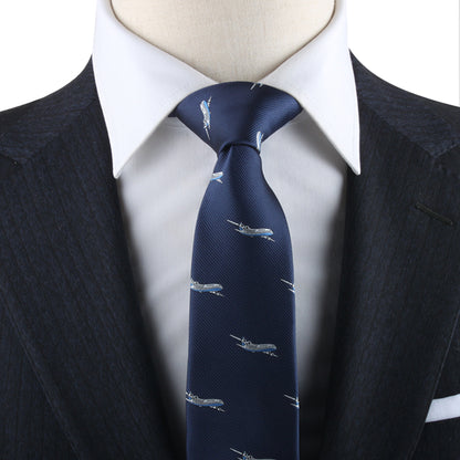 Close-up of a person in a dark pinstriped suit and white dress shirt, wearing an Aeroplane Skinny Tie. The overall look exudes charm and style with an aeronautical touch.