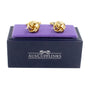 Gold Knot Cufflinks, radiating elegance, displayed on a purple velvet cushion within a black box labeled "AUSCUFFLINKS." Perfect for adding an opulent touch to your wedding attire.