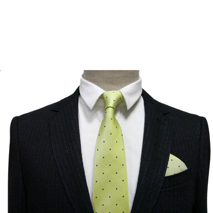 A mannequin elegantly displays a dark pinstripe suit with a white shirt and the Gold Navy Polka Dot Business Tie & Pocket Square Set in lime green, creating an exquisite ensemble designed to impress.