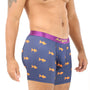 A person in Goldfish Underwear, featuring a vibrant purple design with orange fish patterns, stands sideways, showcasing a tattooed arm and part of the torso, ready to swim in ultimate comfort.